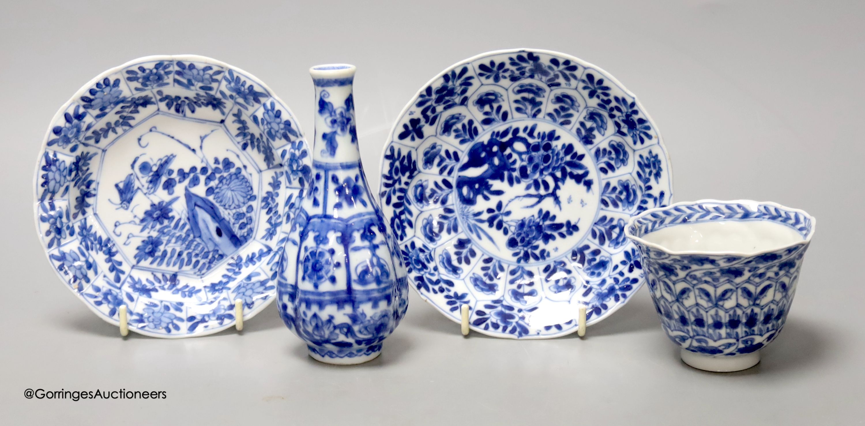 A Chinese blue and white plate 13cm diameter, a similar tea bowl and saucer, Kangxi period and a 19th century Chinese blue and white bottle vase